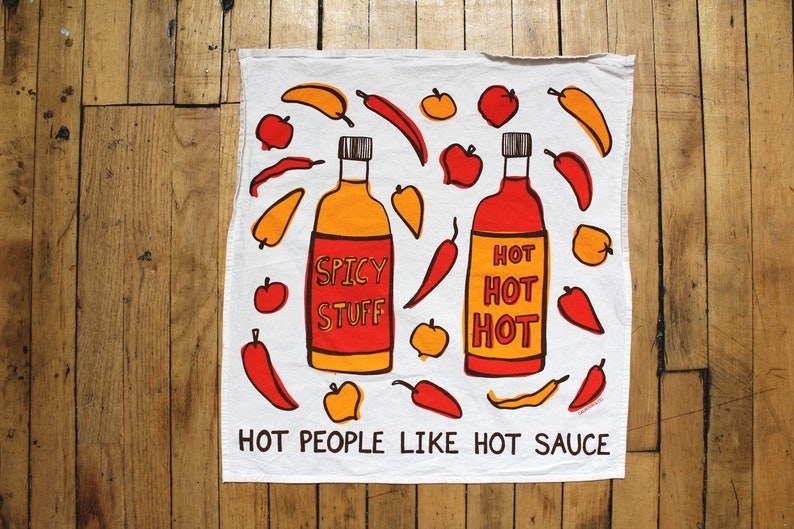 tea towel that has pictures of hot sauce and peppers on it