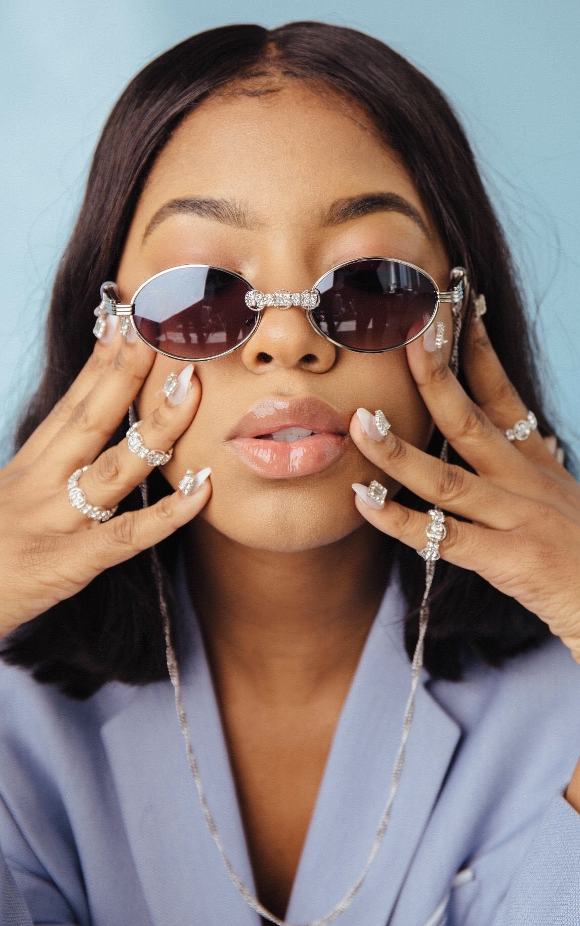 someone wearing the crystal rings with silver loops on multiple fingers