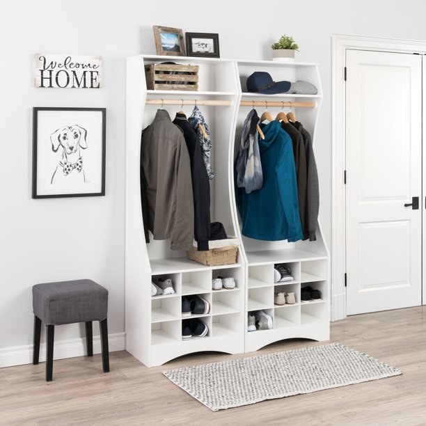 two of the white wardrobes with shoes and coats hanging on the rack