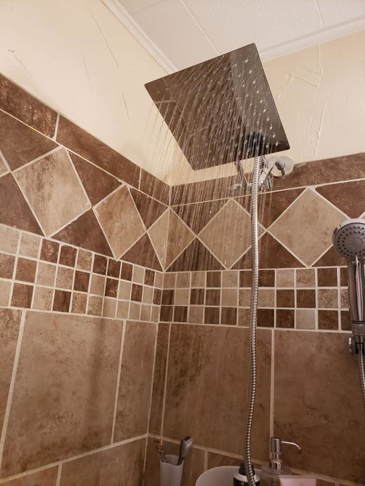 Reviewer&#x27;s shower with rainfall shower head installed