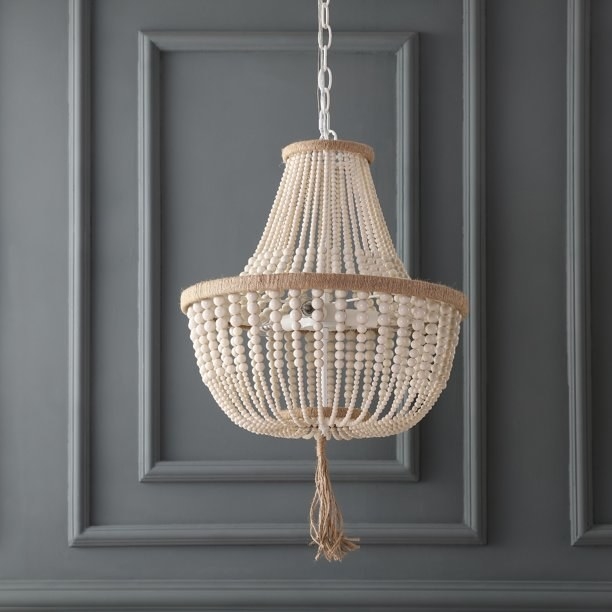 the brown beaded chandelier against a gray wall
