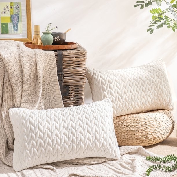 two of the braided pillows in white and cream