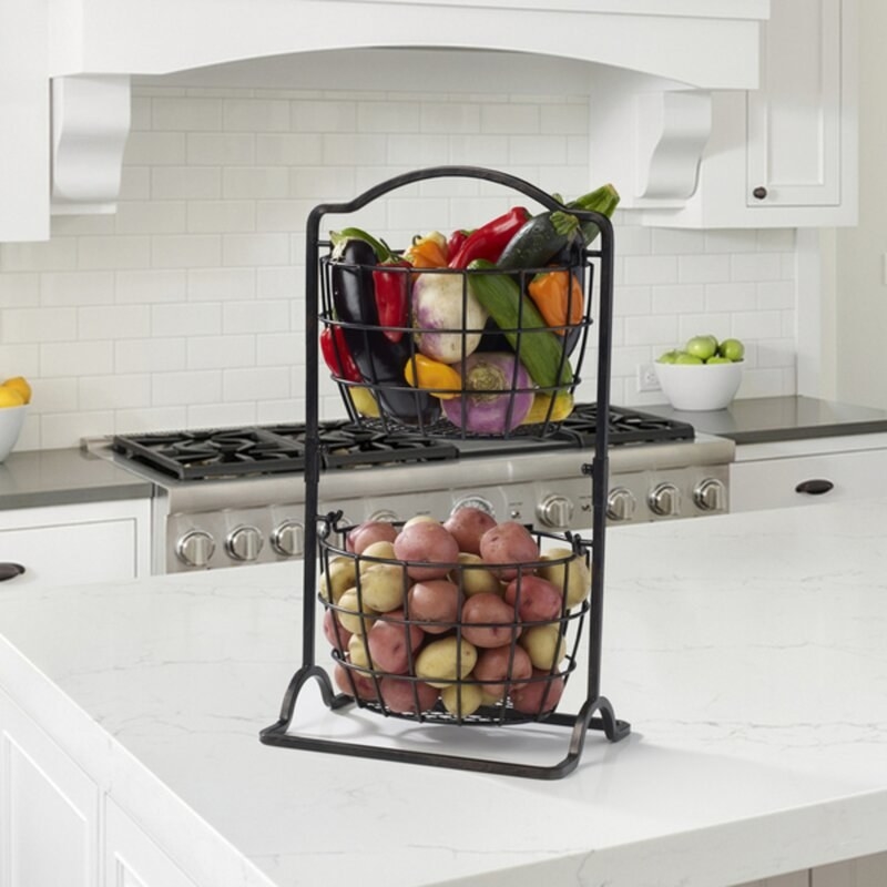 The double level fruit basket with fruit and vegetables inside