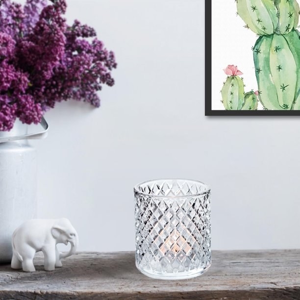the glass candle votive with a candle in it