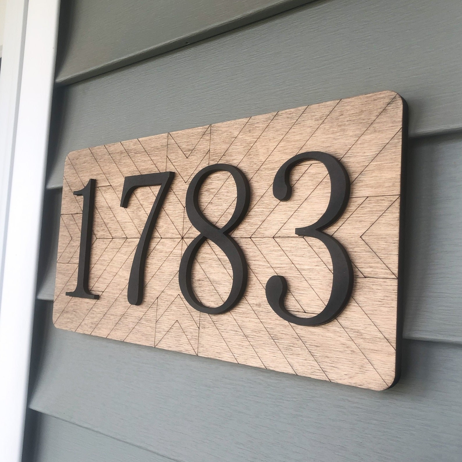 address sign mounted on side of house