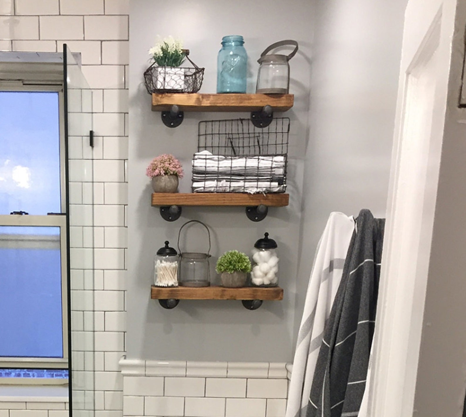bathroom with thick wood open shelves on the wall