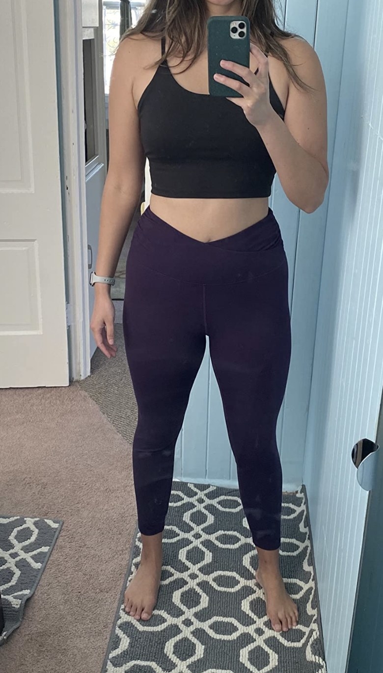 a reviewer wearing the leggings in purple