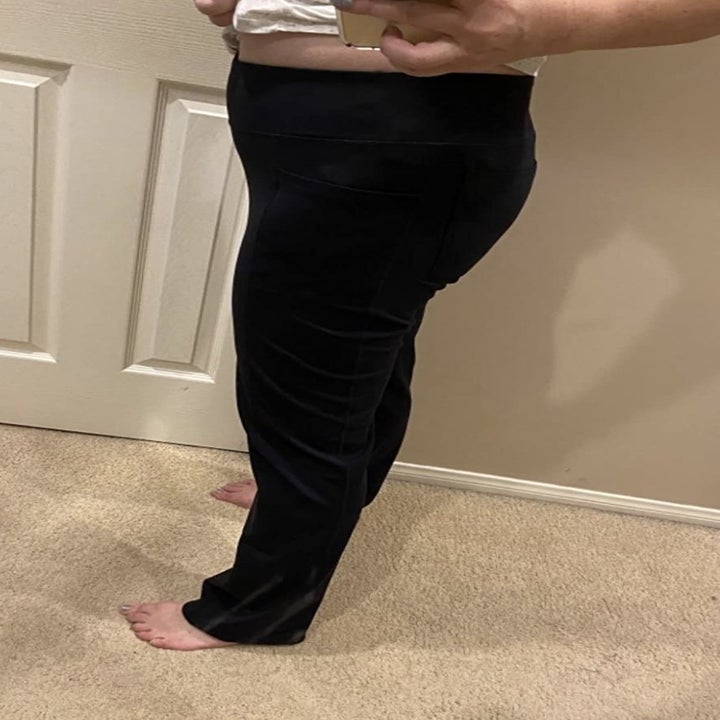 side view of reviewer wearing the pants in black