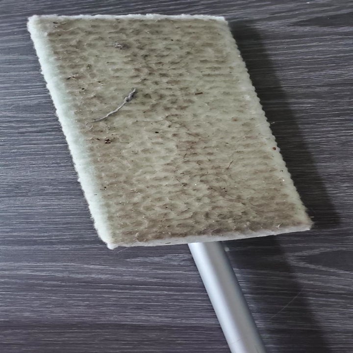 reviewer photo of the dirty Swiffer after sweeping the floor