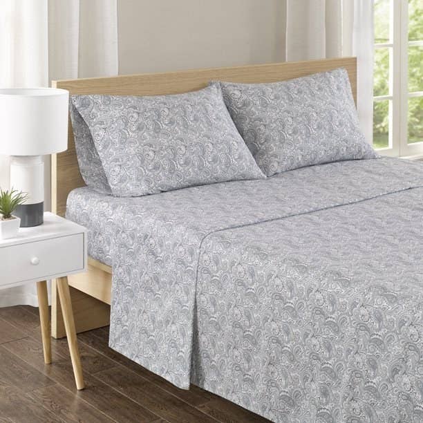 bed with blue paisley sheets and pillows
