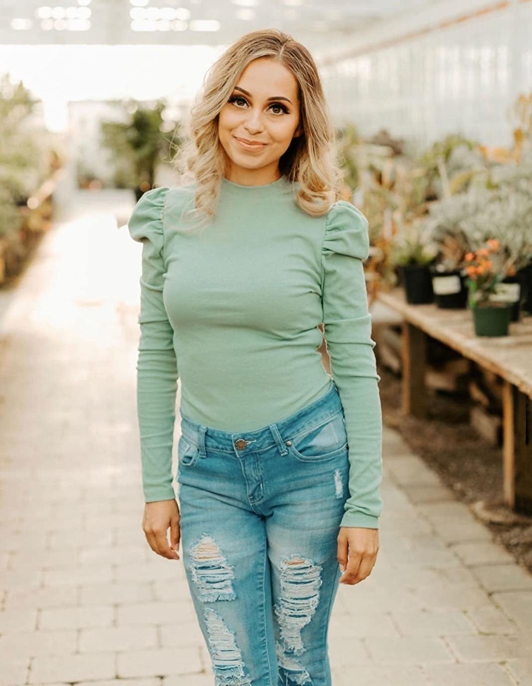 Reviewer wearing mint colored top
