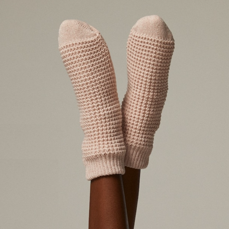A person&#x27;s feet with thick knit socks on them