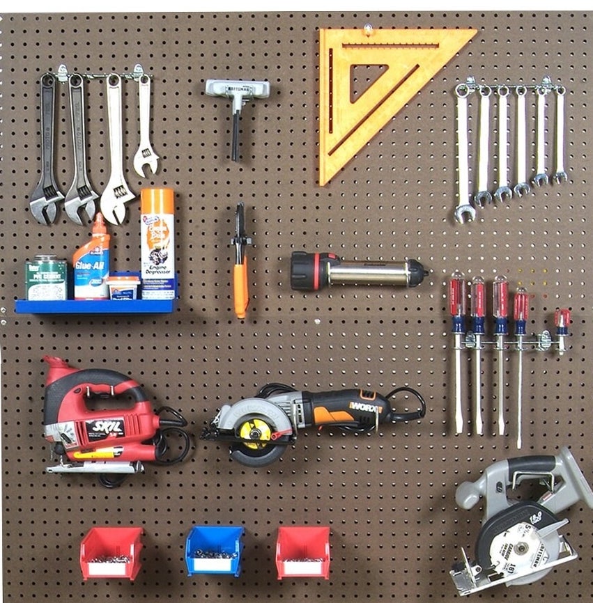 The pegboard with assorted tools on it