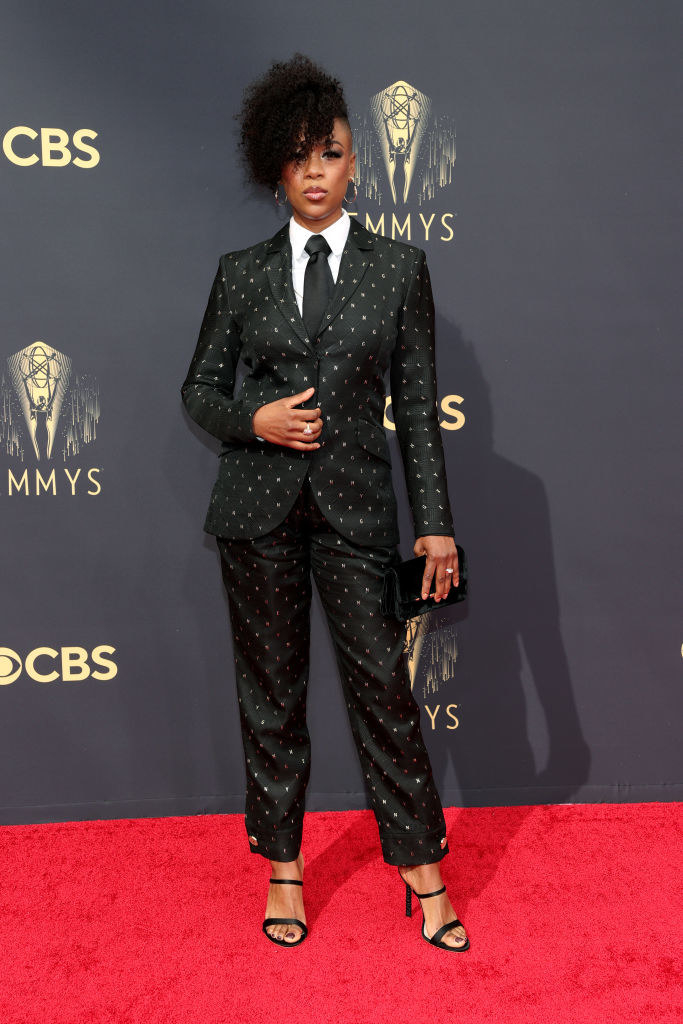 Samira Wiley on the red carpet in a black suit with gold polka dots