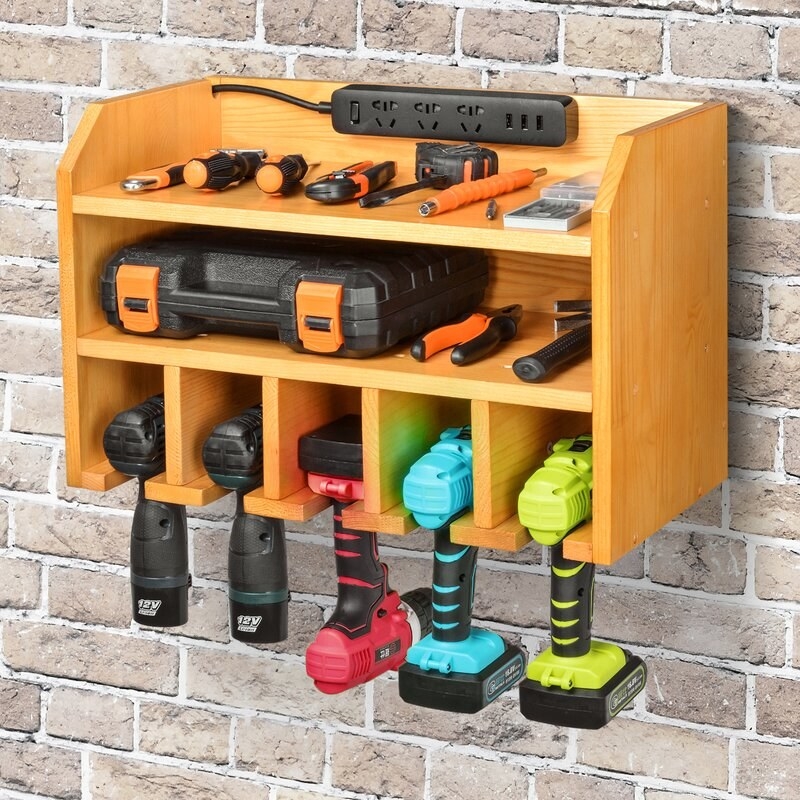 The wall mounted shelf with multiple drills and other tools on it