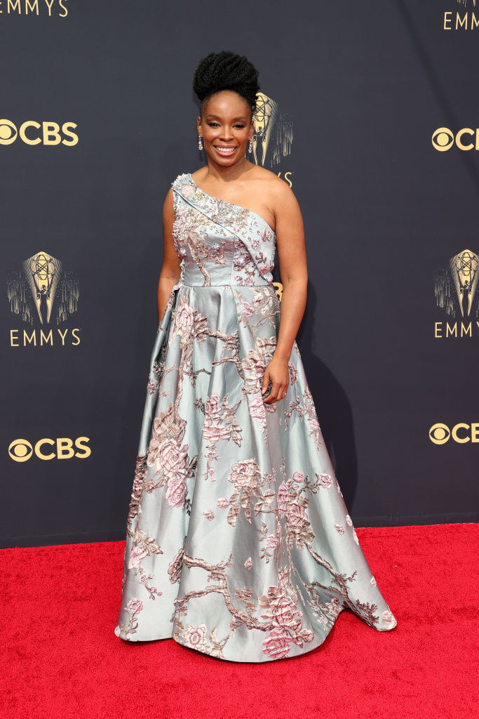 Amber Ruffin on the red carpet in a light blue satin gown with pink floral embroidery