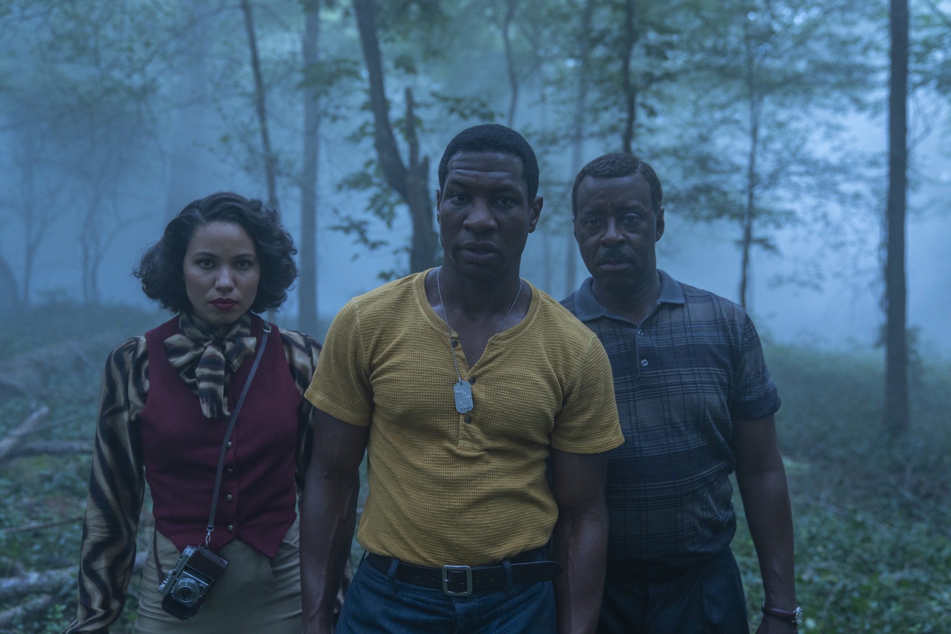 Atticus, Leti, and George walking through a foggy forest