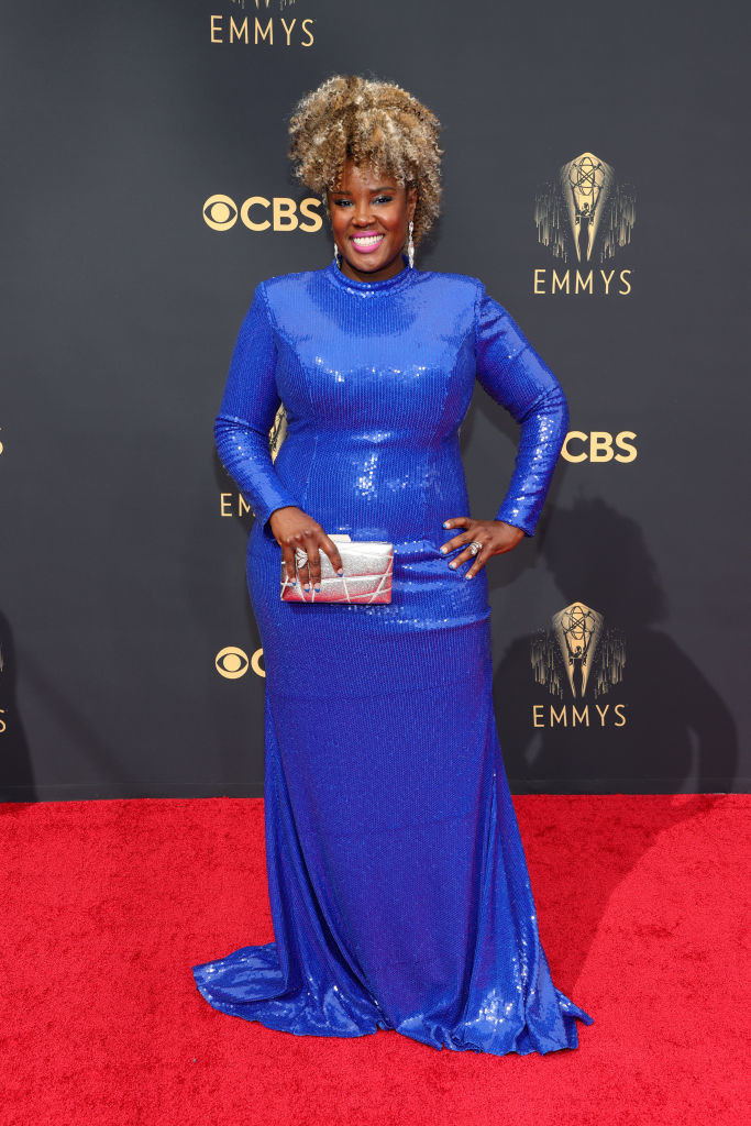 Akilah Green on the red carpet in a high neck blue sequin gown