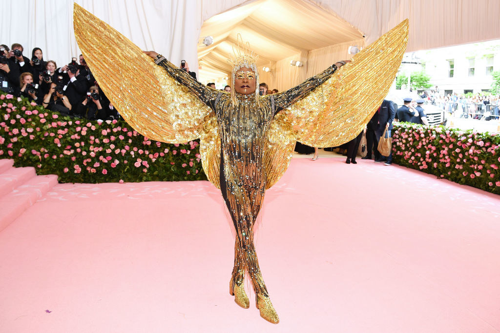 Billy Porter attends The 2019 Met Gala Celebrating Camp: Notes on Fashion in a metallic bodysuit with matching headpiece and massive wings
