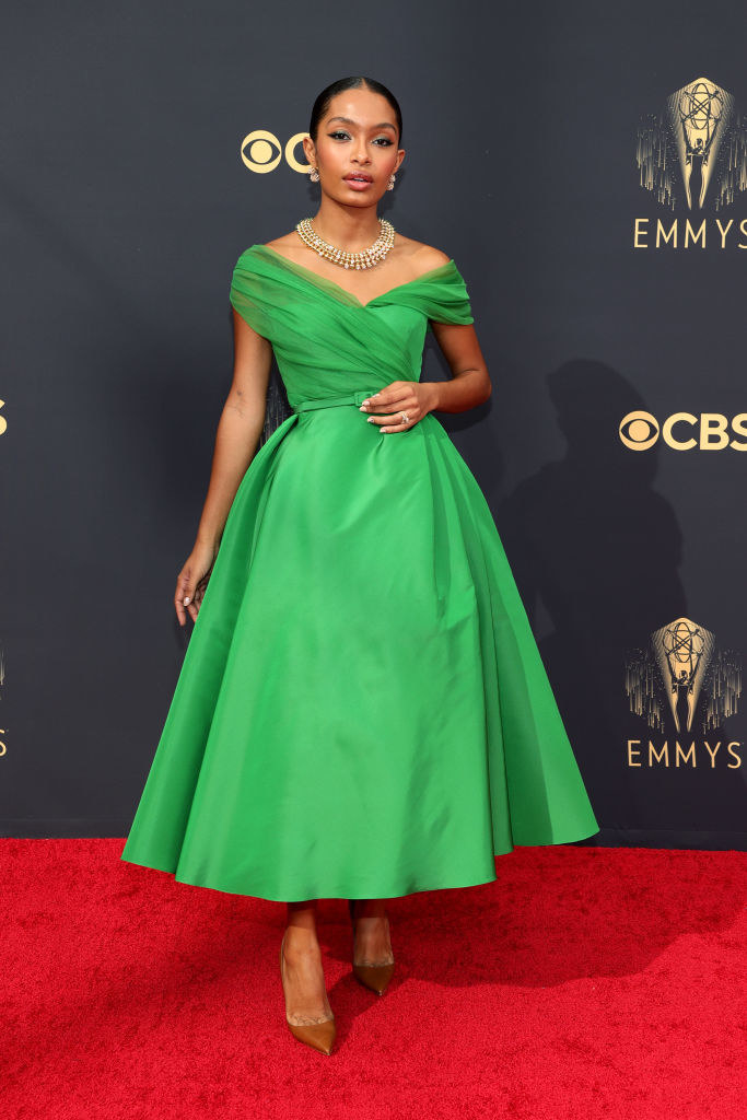 Yara Shahidi on the red carpet in a bright green calf length &#x27;50s style dress