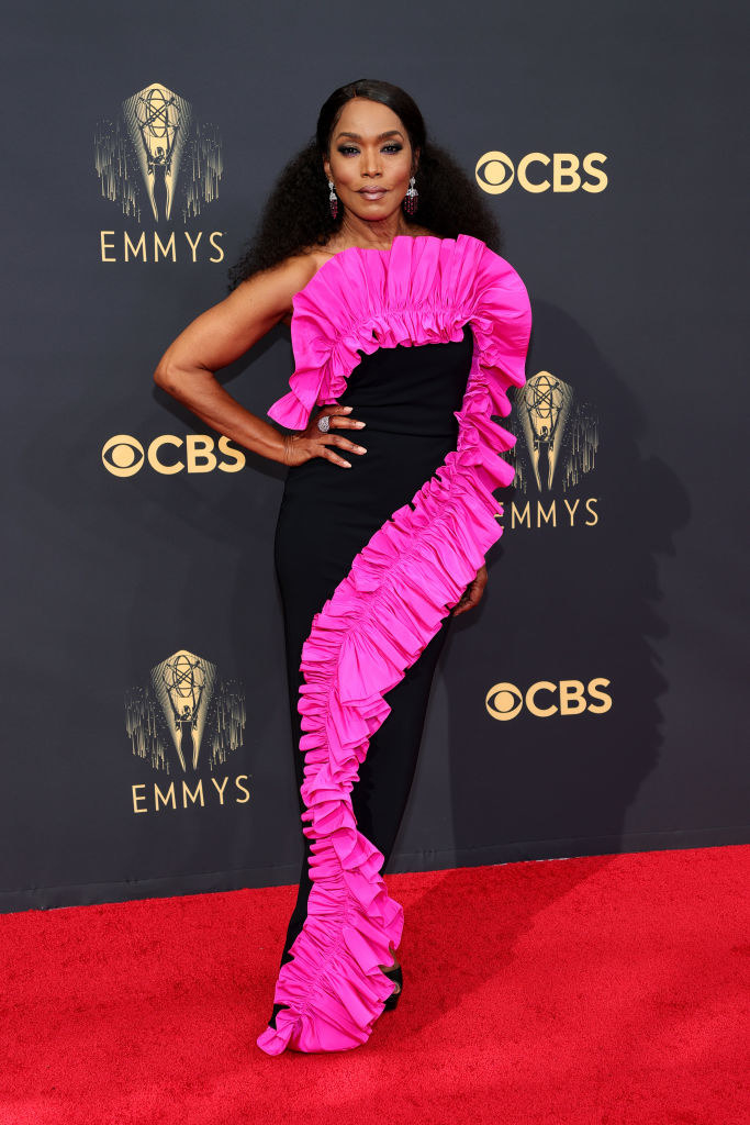 Angela Bassett on the red carpet in a black and bright pink gown