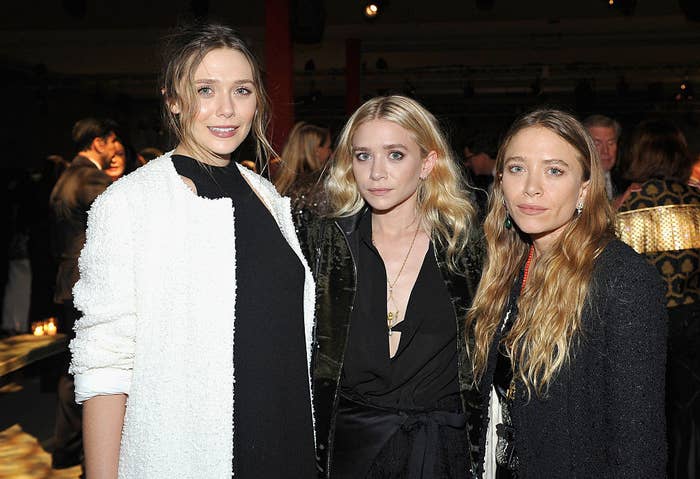 The three sisters posing together for a photo at an event