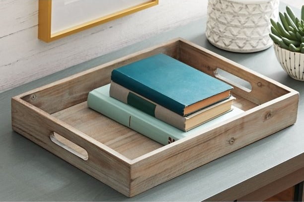 wooden tray with books inside