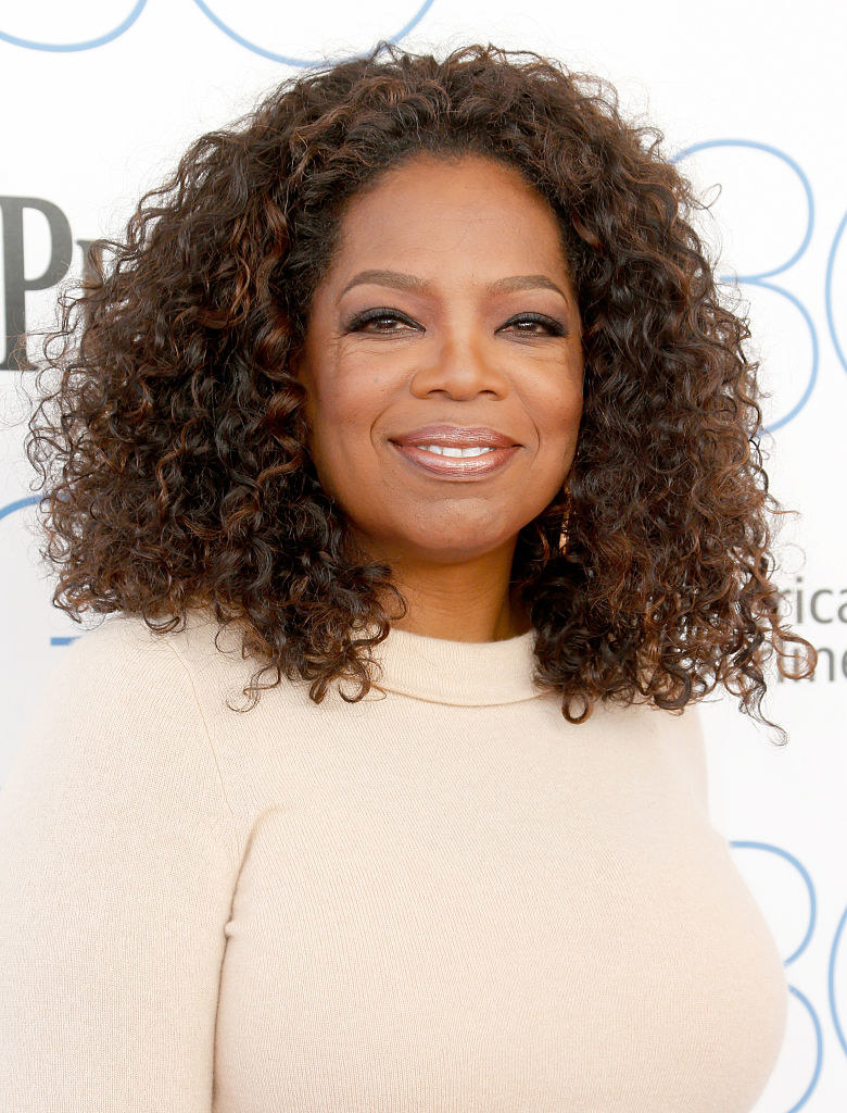 Winfrey smiling in a cashmere sweater