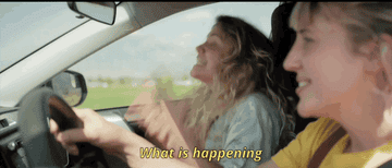 GIF of two women in a car, one of them yelling, with subtitle: What is happening