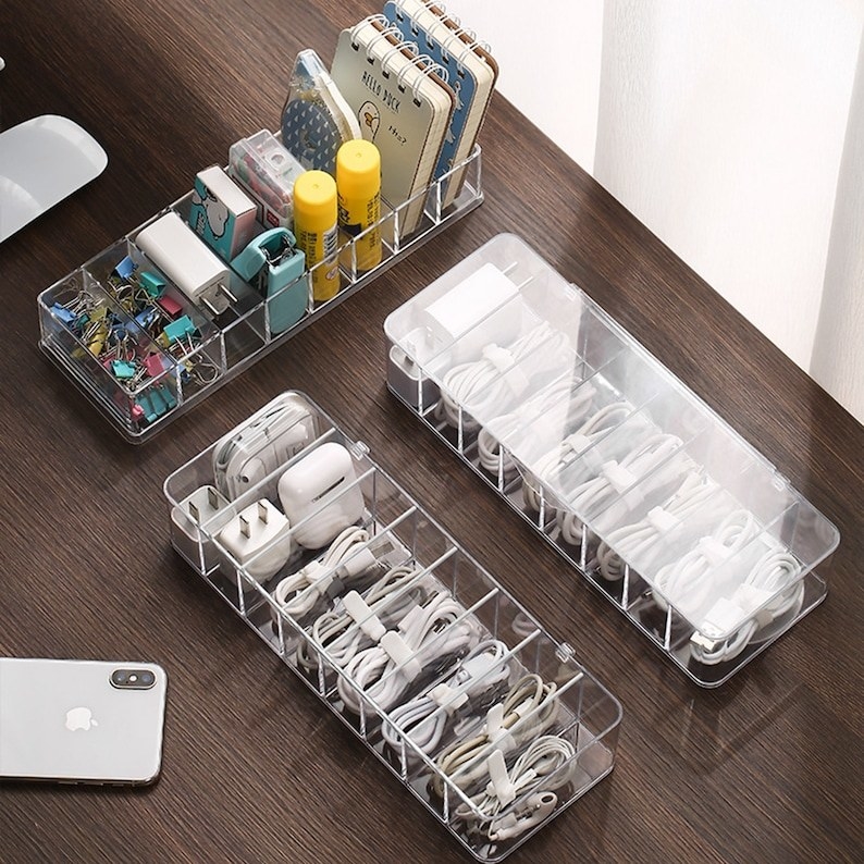 two clear storage boxes with eight different cords in it