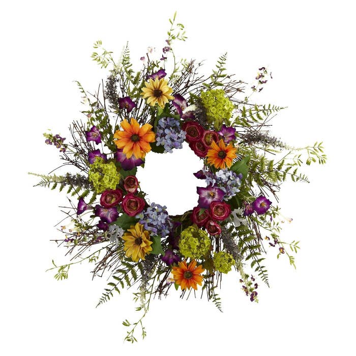 The wreath with yellow, red, pink, purple, and green flowers on it