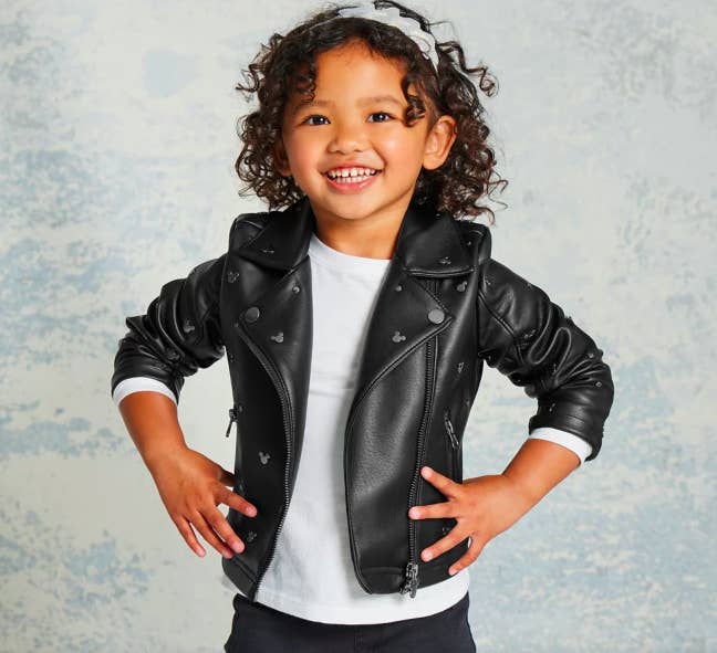 small child in black jacket with silver mickey mouses
