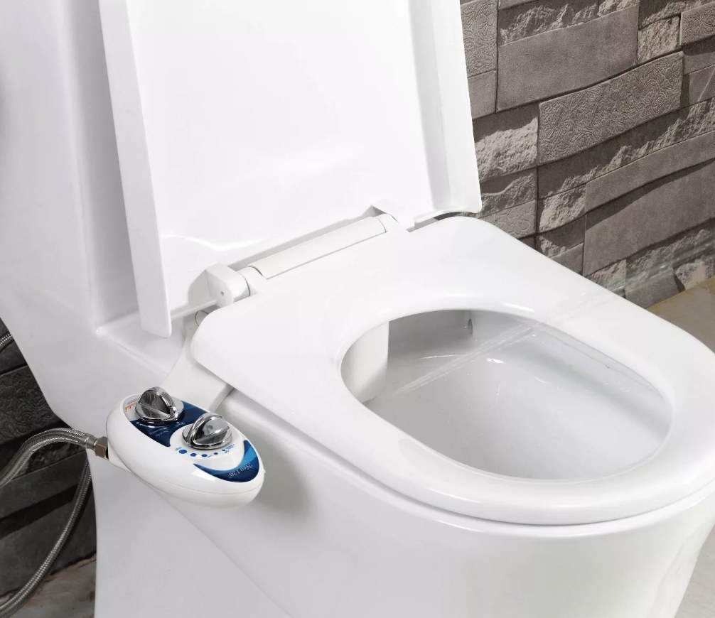 A bidet attachment on the side of a toilet