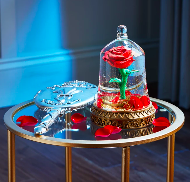 snow globe shaped like the bell jar with the rose in it