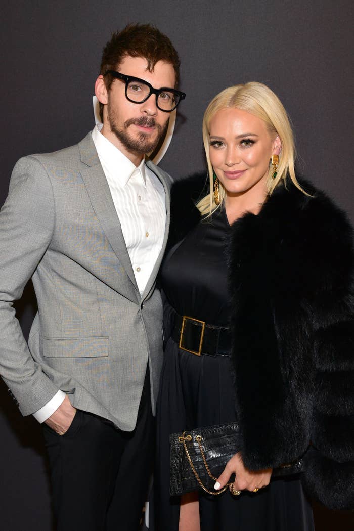 Matthew and Hilary stand together on the red carpet