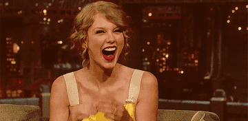 Taylor Swift laughing on a late show.