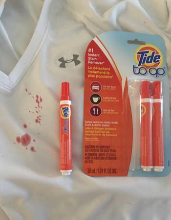 reviewer image of tide to go pens next to a stain on a shirt