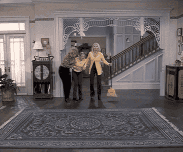 A gif from Sabrina the Teenage Witch where as they are cleaning, their new furniture falls from the sky into their living room