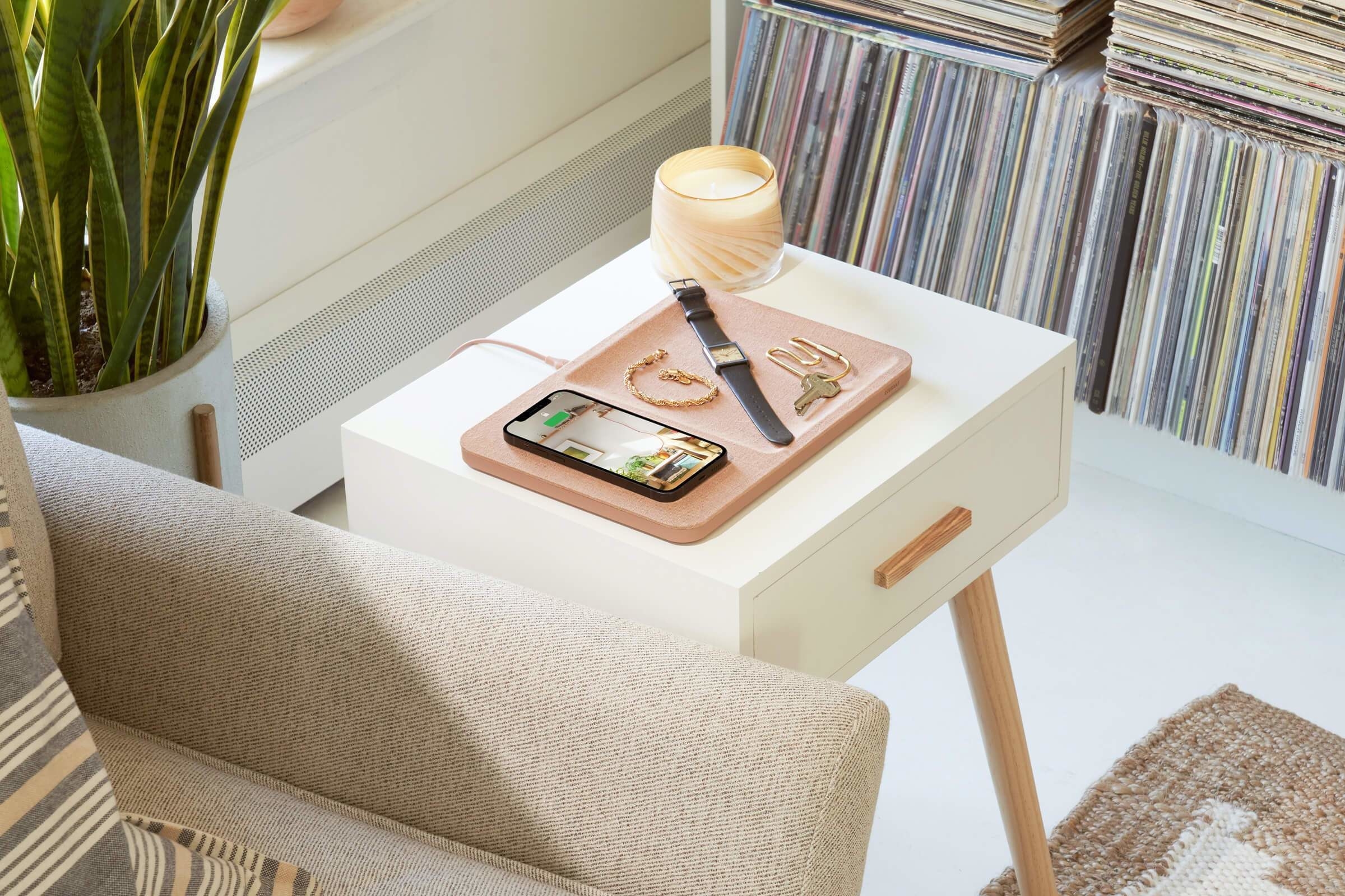 square-shaped wireless charger with tray in it sitting on a side table