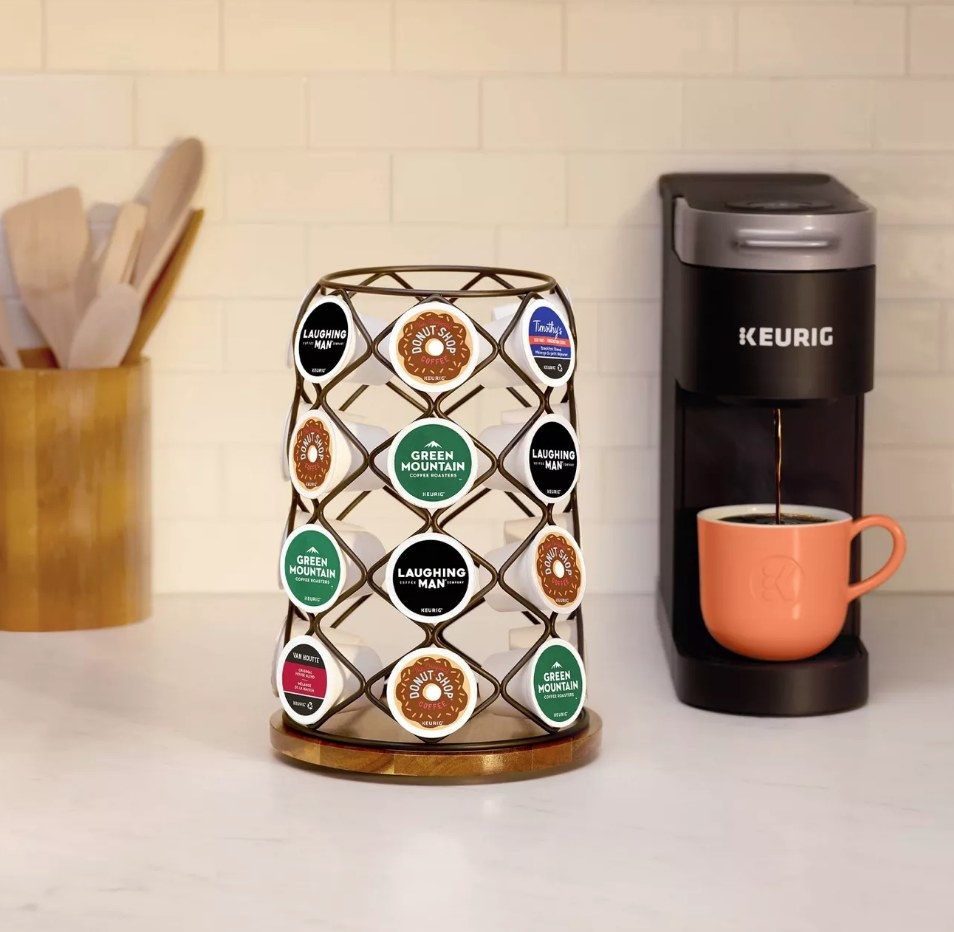 A K-Cup Carousel filled with 49 coffee pods on a kitchen counter aside a Keurig coffee machine