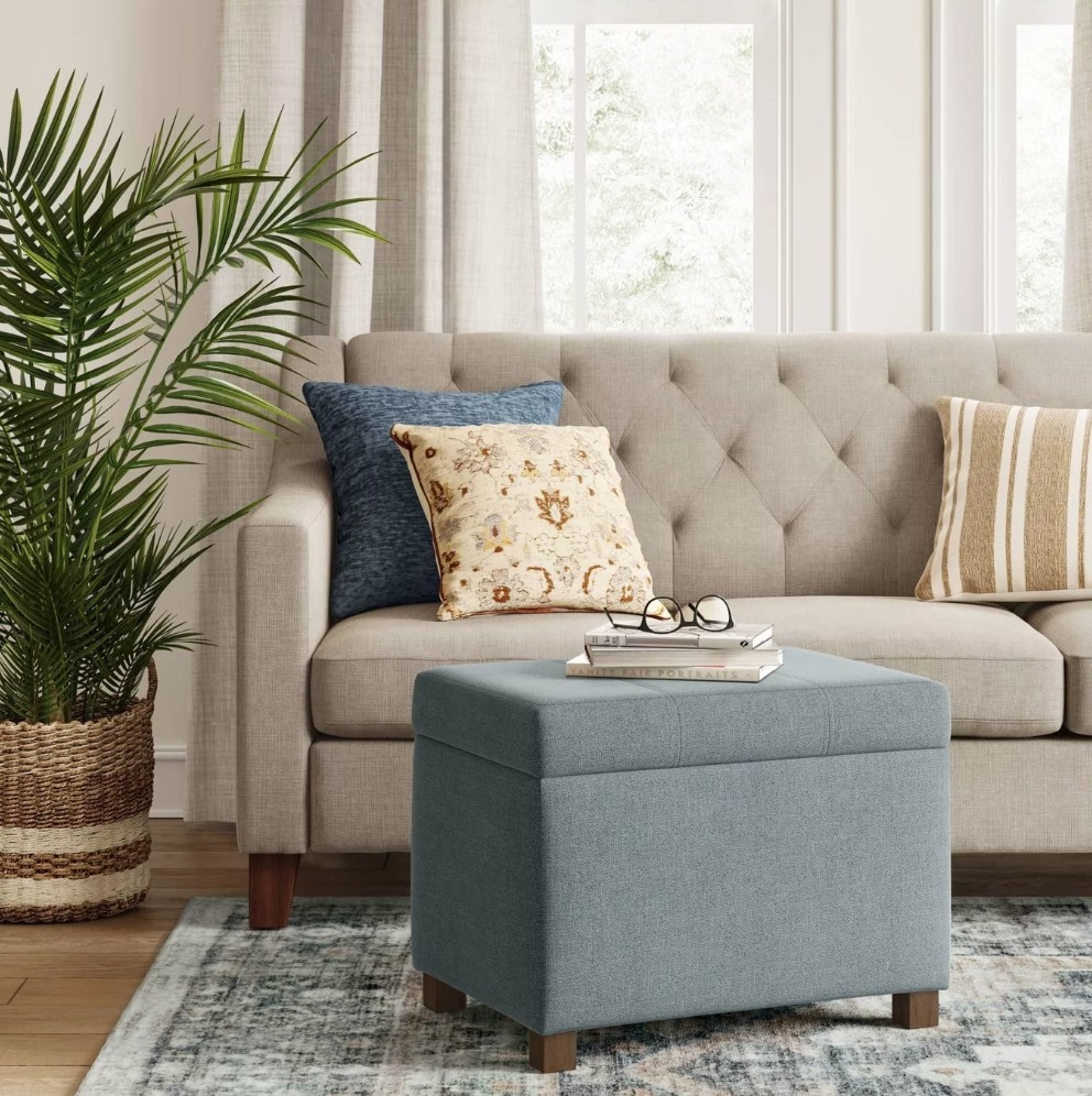 An indigo storage ottoman in a living room