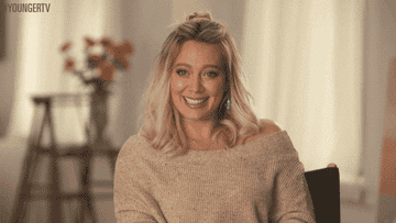 Hilary laughing during an interview on Younger TV
