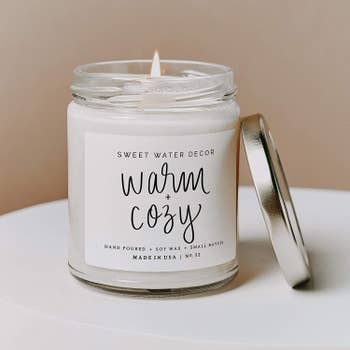a candle with a white label on it that says 