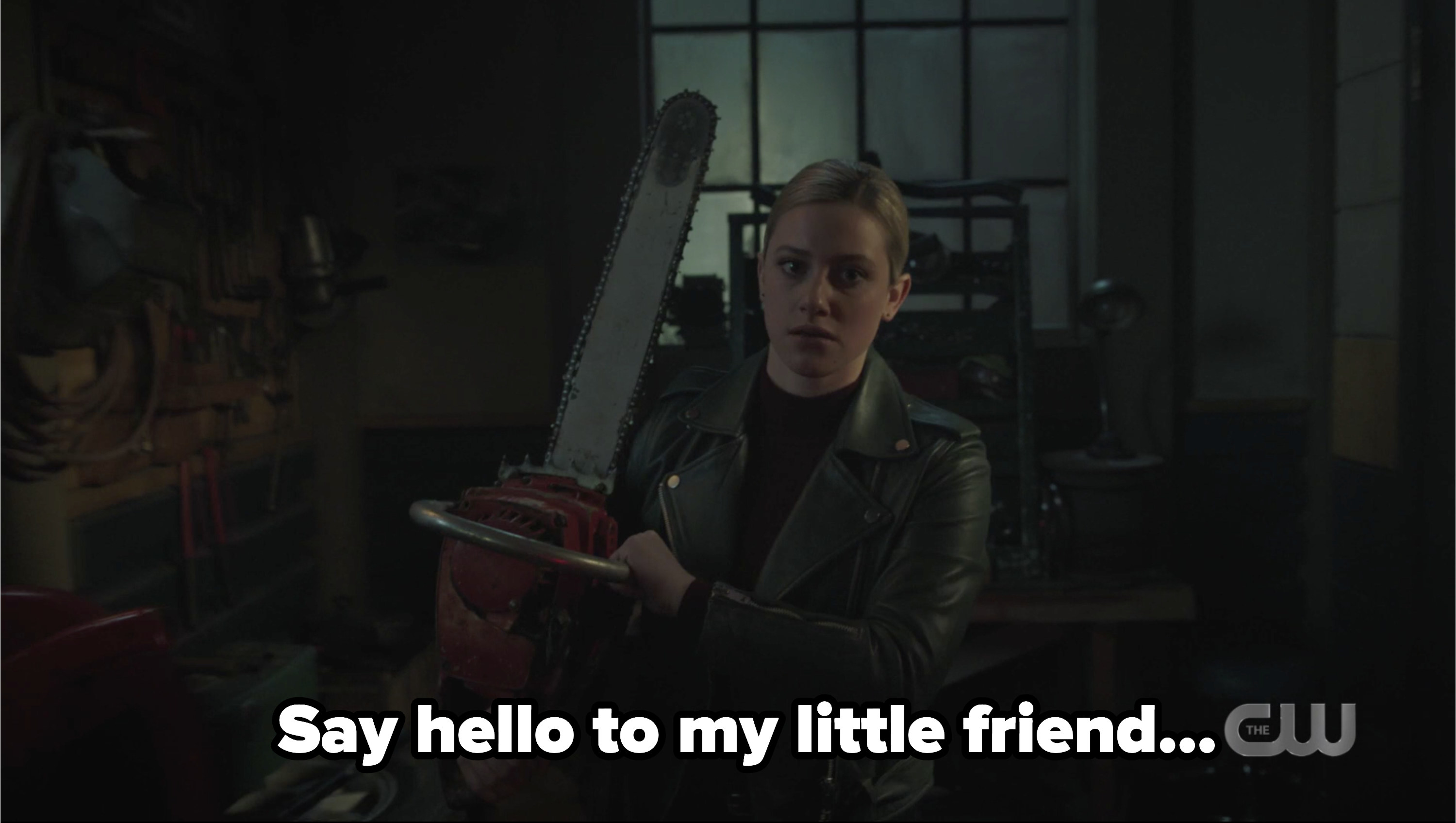 Betty holding a chainsaw with the caption say hello to my little friend