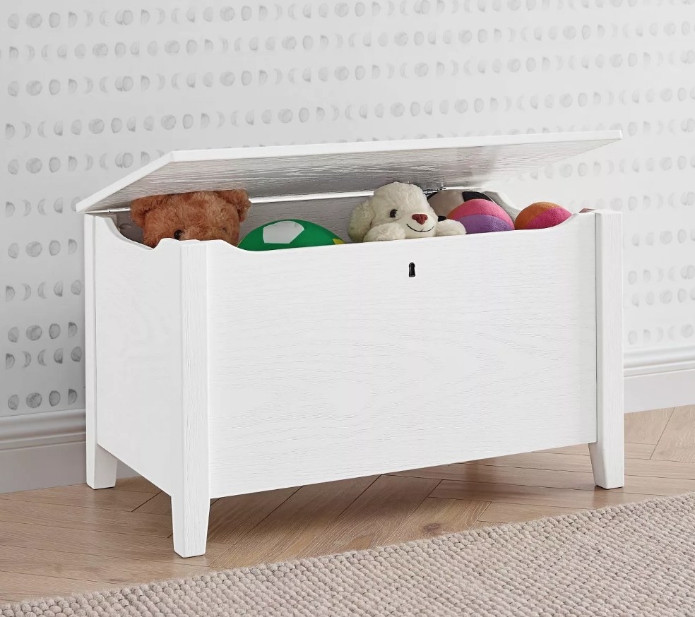 A white, farmhouse style, toy storage bin with a hinged lid