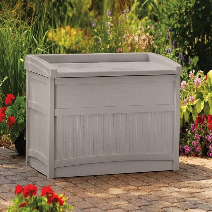 A tan patio storage box with a seat atop