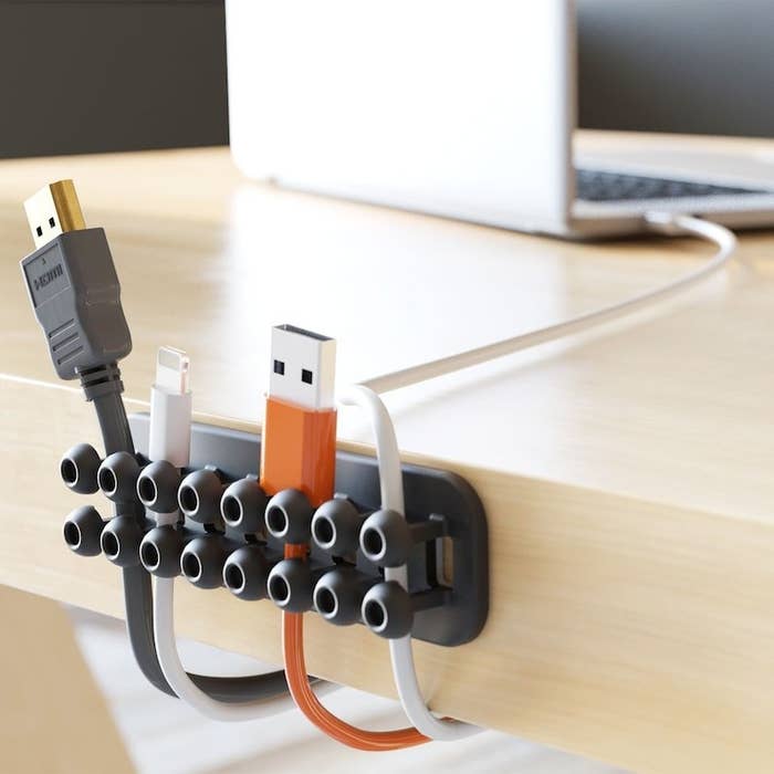 the grid-like organizer with four cables stuck into it