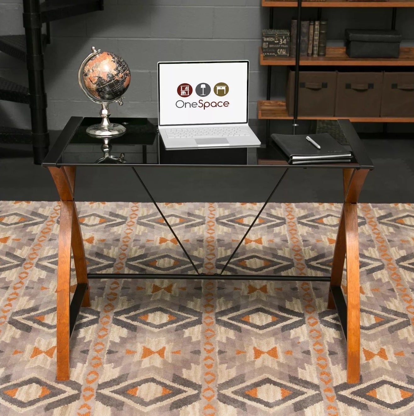 The glass desk with assorted items on top in an office