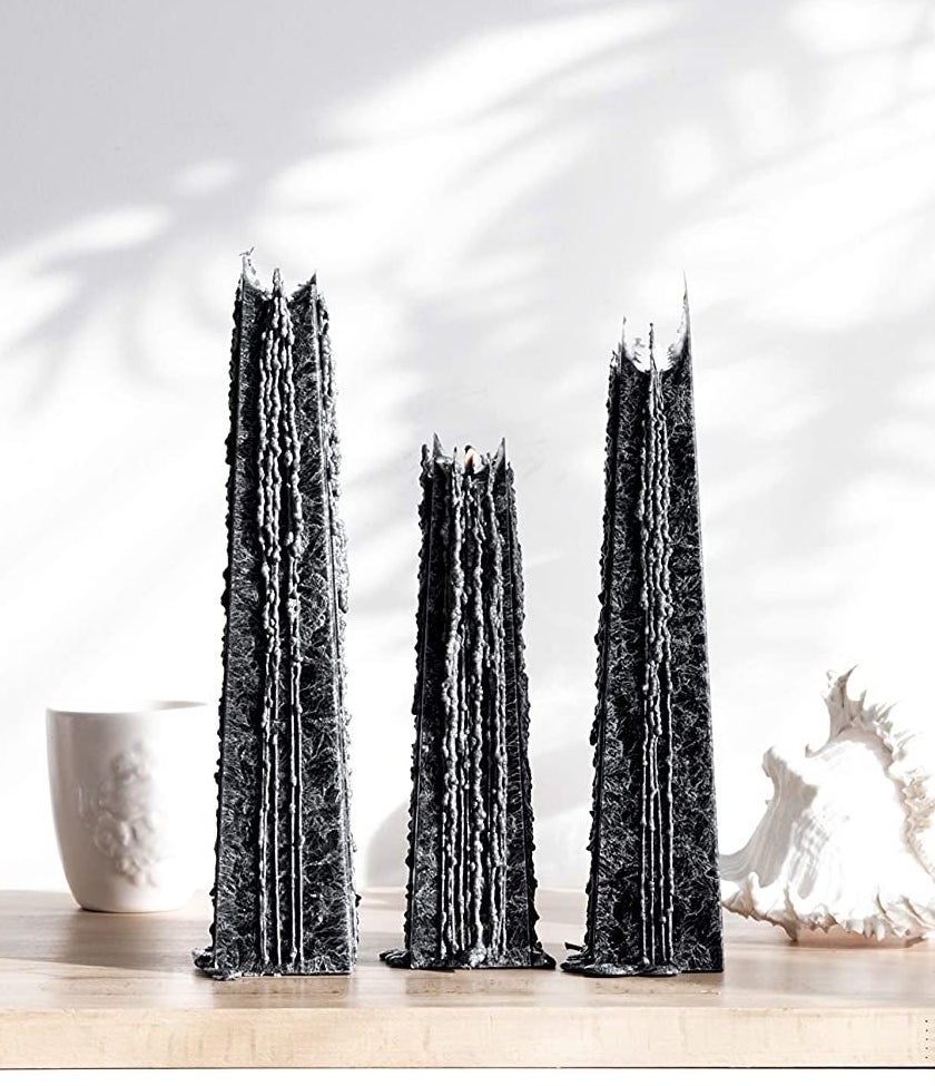 black icicle candles that have been lit and are melting down