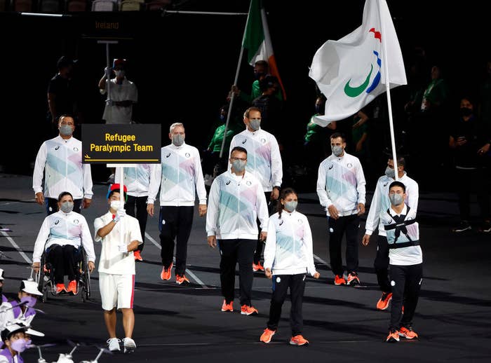 Members of the Refugee Paralympic Team participate in the parade of nations at the Tokyo 2020 Paralympic Games